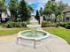 Beautiful three-tiered fountain surrounded by lush landscaping and manicured lawns in the community at 17942 Villa Creek Dr # 17942, Tampa, FL 33647