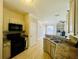 Traditional kitchen featuring tile floors and countertops with a view into the Gathering room at 17942 Villa Creek Dr # 17942, Tampa, FL 33647