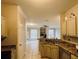 Kitchen open to living area with granite countertop, stainless appliances and tile floor at 17942 Villa Creek Dr # 17942, Tampa, FL 33647