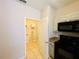 View into laundry room with tile floor, wire shelf, and black appliances at 17942 Villa Creek Dr # 17942, Tampa, FL 33647