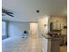 Open-concept living room with neutral walls, tile floors, and ceiling fan at 17942 Villa Creek Dr # 17942, Tampa, FL 33647