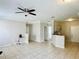 Open-concept living room with neutral walls, tile floors, and ceiling fan at 17942 Villa Creek Dr # 17942, Tampa, FL 33647