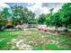 Backyard featuring garden area with greenhouse, providing space for gardening and outdoor activities at 2060 Saffold Park Dr, Ruskin, FL 33570