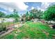 Expansive backyard showcasing garden with an arbor, various pots, and lush landscaping at 2060 Saffold Park Dr, Ruskin, FL 33570