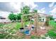 Backyard view showcasing garden area with an arbor, various pots, and outdoor decor at 2060 Saffold Park Dr, Ruskin, FL 33570