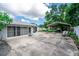 Spacious backyard featuring a screened garage, covered parking, and ample space for outdoor activities at 2060 Saffold Park Dr, Ruskin, FL 33570