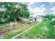 Large backyard with cultivated garden beds and mature shade trees at 2060 Saffold Park Dr, Ruskin, FL 33570