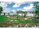 A spacious backyard with garden beds is enhanced by a wooden pergola at 2060 Saffold Park Dr, Ruskin, FL 33570