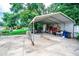 View of the carport and shed in the backyard, offering outdoor storage space at 2060 Saffold Park Dr, Ruskin, FL 33570