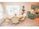 Cozy dining area features a round table, comfortable chairs, and ample natural light at 2060 Saffold Park Dr, Ruskin, FL 33570
