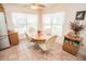 Bright dining area featuring a round wooden table with four rolling chairs and window views at 2060 Saffold Park Dr, Ruskin, FL 33570
