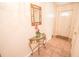 Inviting entryway with tiled floor, decorative table, mirror and soft lighting for a warm welcome at 2060 Saffold Park Dr, Ruskin, FL 33570