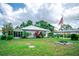 Charming single-story home with a metal roof, landscaped yard, and screened porch for enjoying the outdoors at 2060 Saffold Park Dr, Ruskin, FL 33570