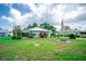 Lovely single-story home with a metal roof, landscaped yard, and a screened in porch area to enjoy the outdoors at 2060 Saffold Park Dr, Ruskin, FL 33570