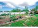 Well-maintained garden with organized raised beds, a fence, and trellises create an inviting landscape at 2060 Saffold Park Dr, Ruskin, FL 33570