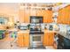 Charming kitchen boasts wooden cabinets, stainless appliances, and ample counter space at 2060 Saffold Park Dr, Ruskin, FL 33570