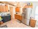 Spacious kitchen with stainless steel refrigerator, wooden cabinets, and tiled floor at 2060 Saffold Park Dr, Ruskin, FL 33570