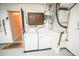 Bright laundry room with washer, dryer, cabinet, and utility connections for efficient home management at 2060 Saffold Park Dr, Ruskin, FL 33570