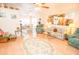 Spacious living room with wood floors, floral furniture, and access to the dining area and sunroom at 2060 Saffold Park Dr, Ruskin, FL 33570
