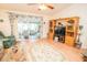 Inviting living room with wood floors, ceiling fan, floral sofa, and view to the sunroom at 2060 Saffold Park Dr, Ruskin, FL 33570