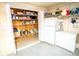 Organized pantry space with shelving, refrigerator, and freezer for ample storage and convenience at 2060 Saffold Park Dr, Ruskin, FL 33570