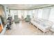 Bright sunroom with plenty of natural light, comfortable seating, and exercise equipment at 2060 Saffold Park Dr, Ruskin, FL 33570