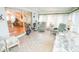 Bright sunroom features cozy seating, exercise bike, and relaxing natural light at 2060 Saffold Park Dr, Ruskin, FL 33570