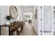 Welcoming entryway with wooden console table, round mirror, and view into the living room at 2320 Stratten Dr, Zephyrhills, FL 33541