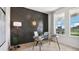 Stylish home office with modern glass desk, accent wall, and a bright window view at 2320 Stratten Dr, Zephyrhills, FL 33541