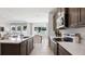 Gourmet kitchen with stainless steel appliances, eat-in island and a view of the living room at 2320 Stratten Dr, Zephyrhills, FL 33541