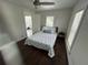 Bright bedroom features hardwood floors, ceiling fan, and nautical-themed bedspread at 2321 Trelain S Dr, St Petersburg, FL 33712