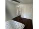 Cozy bedroom featuring hardwood floors and a nearby closet at 2321 Trelain S Dr, St Petersburg, FL 33712