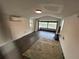 Bright room with hardwood floors, large bay window, and modern mini split system at 2321 Trelain S Dr, St Petersburg, FL 33712