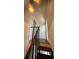 A close-up of a stairway with dark wooden railings and a decorative overhead light fixture at 2321 Trelain S Dr, St Petersburg, FL 33712