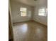 Light-filled bedroom featuring tile floors and dual windows, ready for your personal touch at 2354 7Th S St, St Petersburg, FL 33705