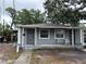 Charming single-story home with a cozy front porch and mature shade trees in a residential neighborhood at 2354 7Th S St, St Petersburg, FL 33705