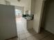 This functional kitchen features white cabinets and appliances with tile flooring at 2354 7Th S St, St Petersburg, FL 33705