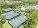 Aerial view of community tennis courts with the pool and recreation area in the background at 27546 Stonecreek Way, Wesley Chapel, FL 33544