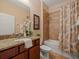 Bathroom with granite vanity, tub, shower with decorative seashell shower curtain at 27546 Stonecreek Way, Wesley Chapel, FL 33544