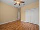 Bedroom featuring wood floors, a ceiling fan and a closet at 27546 Stonecreek Way, Wesley Chapel, FL 33544