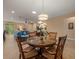 Open floor plan featuring dining area, living room with blue couches, and sliding glass doors to the backyard at 27546 Stonecreek Way, Wesley Chapel, FL 33544