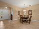 Cozy dining area featuring tile flooring, an elegant table set, tasteful decorations, and an arched entryway at 27546 Stonecreek Way, Wesley Chapel, FL 33544