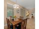 Dining room area with decorative lighting, a sliding glass door, and a view to the main bedroom at 27546 Stonecreek Way, Wesley Chapel, FL 33544