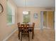 Comfortable dining area with natural light from windows and sliding glass door at 27546 Stonecreek Way, Wesley Chapel, FL 33544