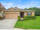 Inviting one-story house with a two-car garage and beautiful landscaping at 27546 Stonecreek Way, Wesley Chapel, FL 33544