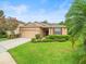 Beautiful one-story home featuring a well-kept lawn, landscaping and a two-car garage at 27546 Stonecreek Way, Wesley Chapel, FL 33544