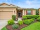 Lovely home with a well-manicured front yard and stone accents at 27546 Stonecreek Way, Wesley Chapel, FL 33544