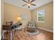 Home office with a desk, chair, ottoman, ceiling fan, and natural light at 27546 Stonecreek Way, Wesley Chapel, FL 33544