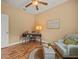 Well-lit home office with wood floors, a modern desk, and comfortable seating area at 27546 Stonecreek Way, Wesley Chapel, FL 33544