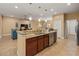Bright kitchen island featuring granite counters, a stainless steel dishwasher, and views into the Gathering room at 27546 Stonecreek Way, Wesley Chapel, FL 33544